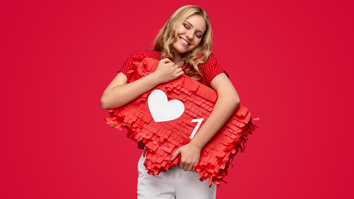 woman hugging an instagram like icon pinata