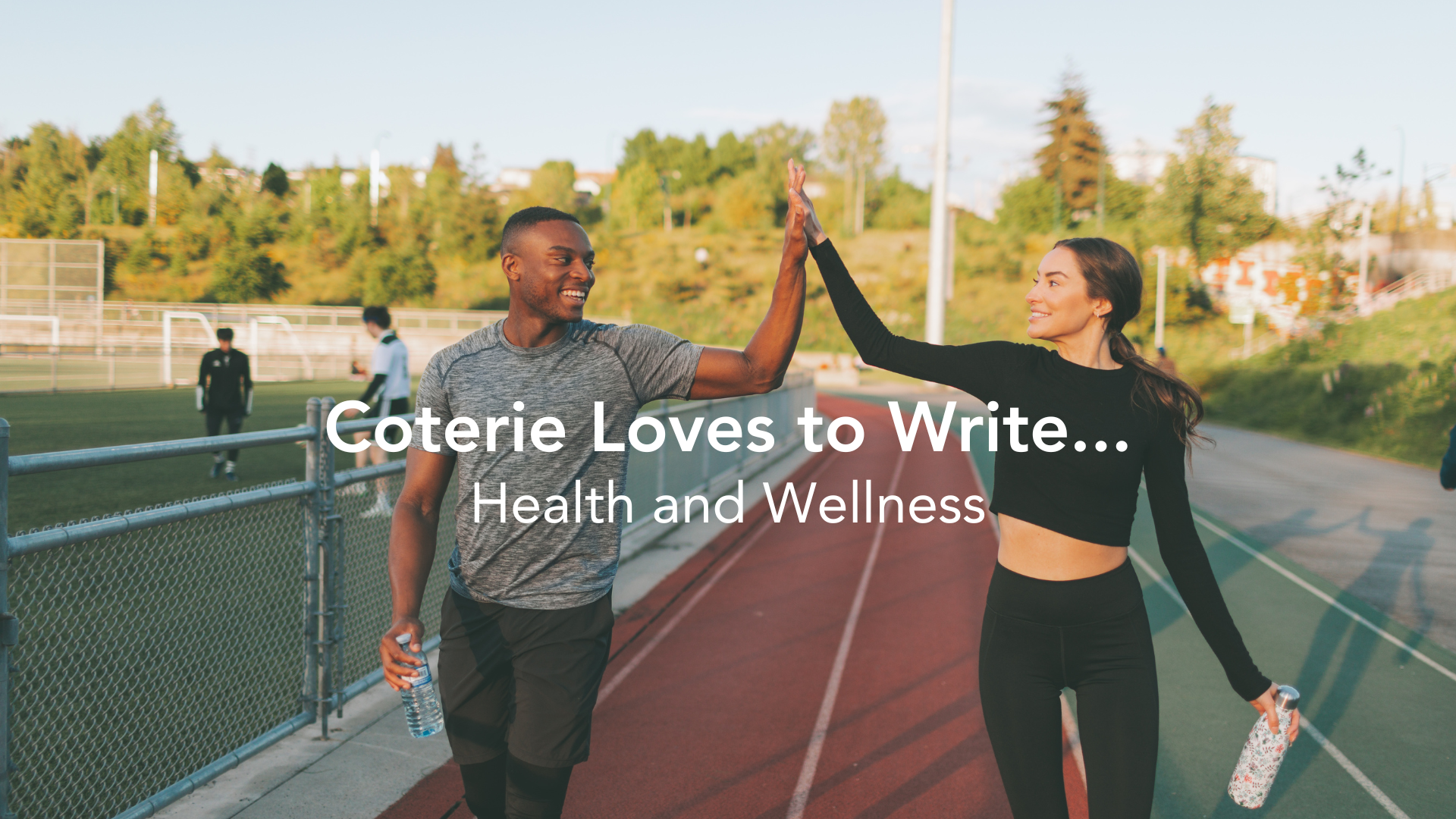 Coterie Insurance loves to write business classes in health and wellness category. Image of man and woman high giving after finishing a run around a track.